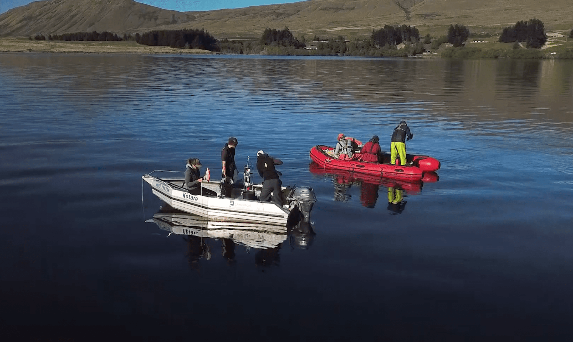 Collecting lake samples New Zealand