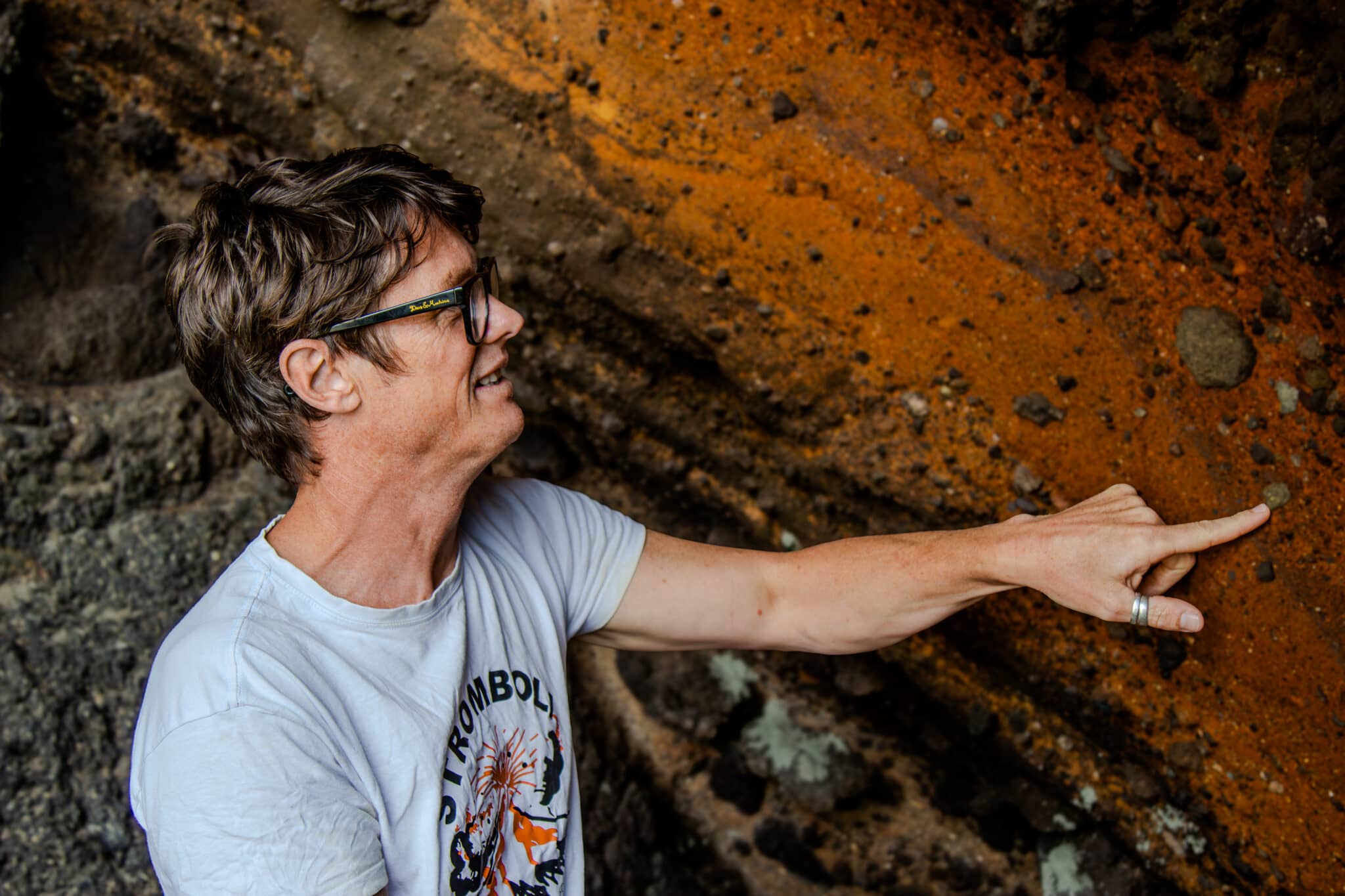 Volcanologist Ben Kennedy points to rock.